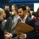 Impress at career fairs: Fahad Jan talks with company representives during the graduate career fair.