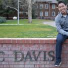 Communication major Chinsin Sim sitting on the East UC Davis Wall