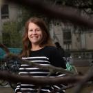 Environmental portrait of Amy Lowrey behind a tree branch