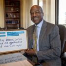 Chancellor Gary S. May with sign showing support for DACA students.