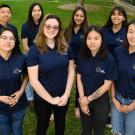 Photo of eight students wearing Aggies Helping Aggies polo shirts.