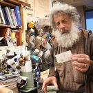 Art Shapiro holds the first cabbage white butterfly found in the region this year.