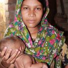 Woman in scarf holding a baby