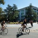 Students ride bicycles in a bike circle.