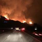 Fire trucks drive toward the Thomas Fire.