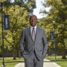 Chancellor Gary S. May, smiling, poses on Centennial Walk.