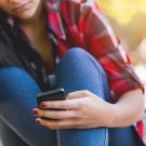 Girl seated and texting