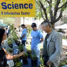 Guy Kyser, far right, speaks to an attendee at Picnic Day.