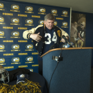 Dan Hawkins puts on his UC Davis letterman jacket.