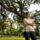 Ingrid Bergman stands amid trees on the Quad.