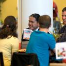 Ken Burtis chates with a table full of students in the Dining Commons.