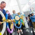 Photo: Ralph J. Hexter unties ribbon in museum chain.