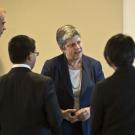 Janet Napolitano interacts with UC Merced students who are gathered in a half circle around her.