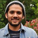 Man in gray cap poses in the UC Davis Arboretum