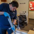 Aldo Lopez cleans a dorm room.