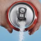 Photo of sugar pouring out of soda can