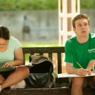 Two students draw outside in the summer