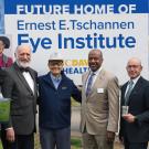 Executives and donor pose in front of sign announcing the "Future Home of Ernest E. Tschannen Eye Institute" at UC Davis Health.