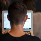 A student types an email on a laptop computer.