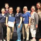 Veterinary affiliates lined up photo with certificate of commendation.