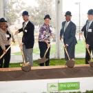 Officials from UC Davis shovel dirt during groundbreaking ceremony.