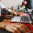 Woman works from home with dog.