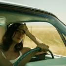 Emily Somers drives a car in her role in the film Into the Valley