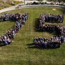 View from above with people spelling out 7-5 on the grass