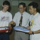 Professor Andrew Frank and three students look at small model cars