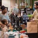 Woman and child at checkout stand buying groceries