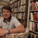 Man sitting on chair with books in background