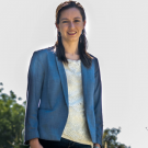 Female scientist standing outdoors in blue jacket