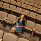 Laci Gerhart sits in one of many lecture hall seats shown