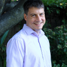 A photo of Paul Eastwick standing in front of a tree.