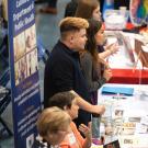 Students talk with prospective employers at a career fair in 2019.