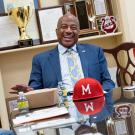 Chancellor Gary S. May sits at a table