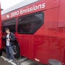 A student recharges an electric Unitrans bus.