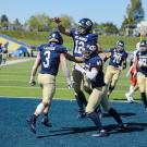 Aggie football players celebrate in endzone.