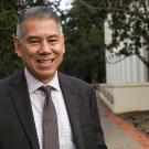 Joe Farrow in suit, smiling.