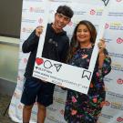 Student Julian Gomez and HSI Director Lina Mendez pose in Instagram photo frame