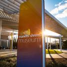 Photo of Manetti Shrem Museum in winter sunshine, showing orange and purple hues