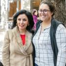 Professor Lorena Marquez stands with a student.