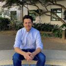 man in blue clothing sitting at UC Davis outdoor spot