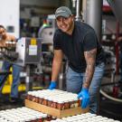 Student helps with beer packaging