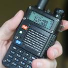 An amateur radio handset in a hand