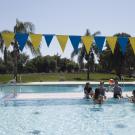 Students enjoy a day in the Rec Pool and play with a beach ball.