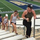 People walk up stairs football stadium