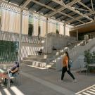 Students sit and study outside the Teaching and Learning Complex.