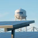 Tops of solar panels with UC Davis water tower in background