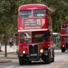 Three vintage double-decker buses at start of parade